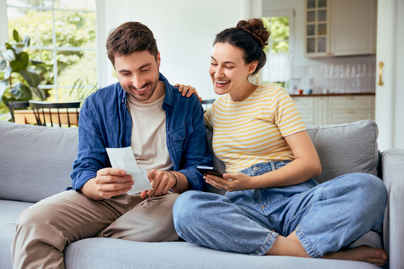 Para siedzi na kanapie i sprawdza rachunki.